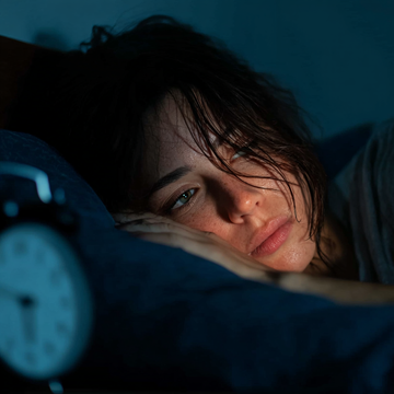 sleepless woman hoping to sleep better and deeper at night