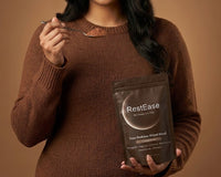 Woman Holding RestEase Cocoa Brew Sleep Powder 
with Scoop Natural Melatonin Free Bedtime Ritual